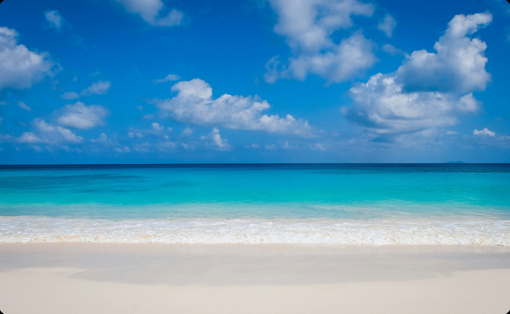 A photo of looking out to sea from a sandy beach.