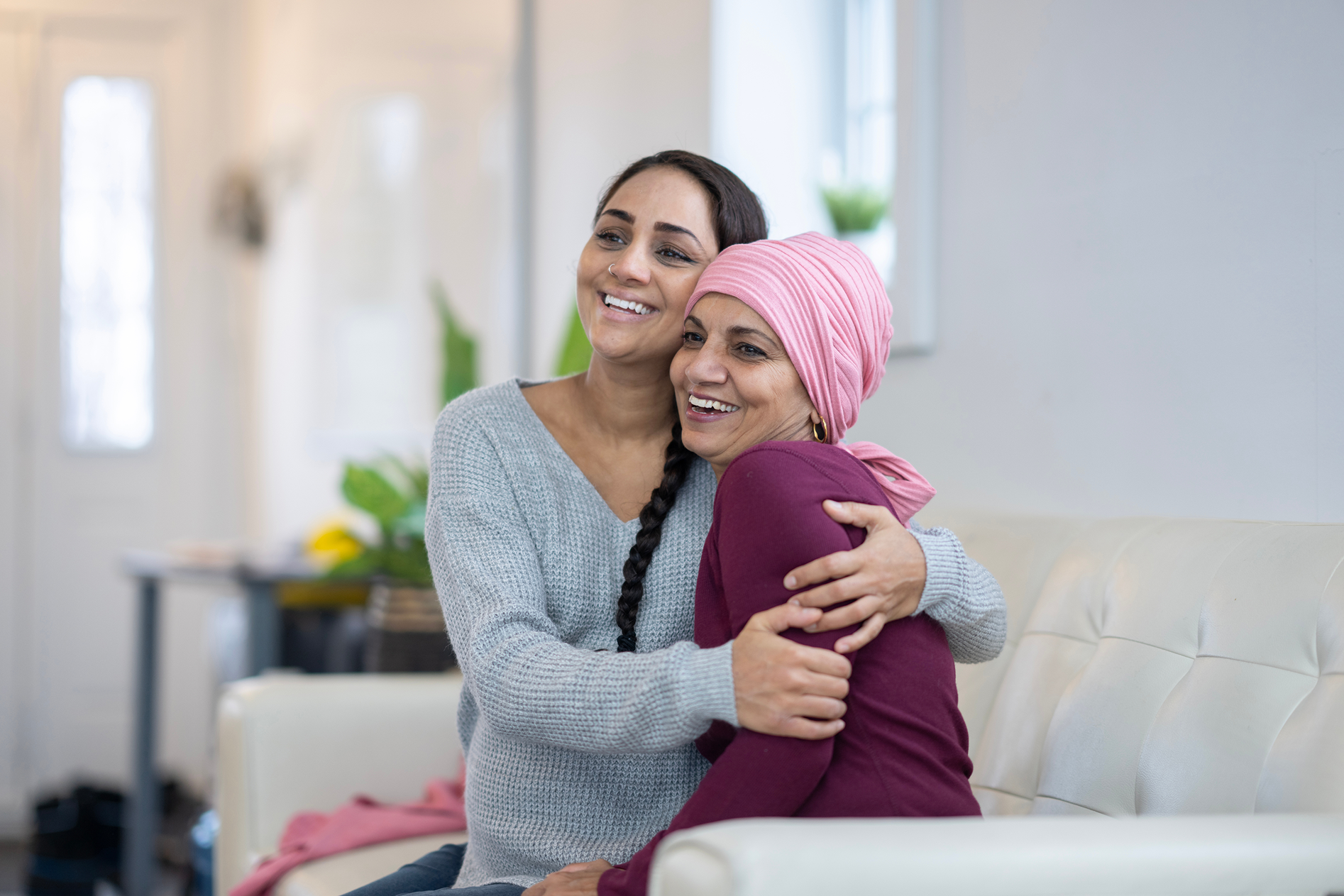 Two women smiling and embracing